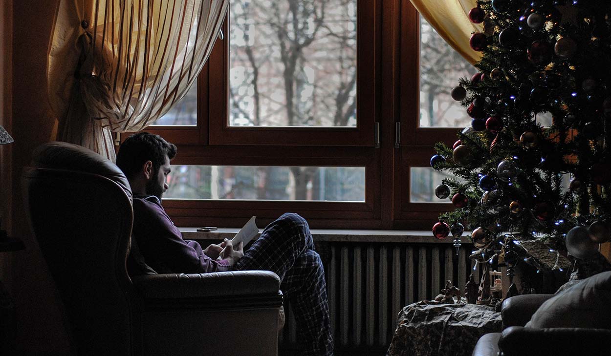 Man reading by a window