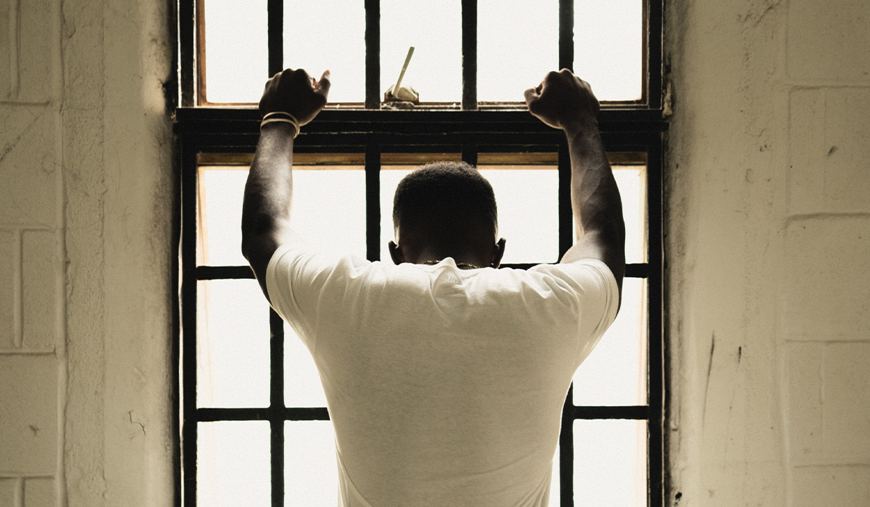 Man leaning against a window