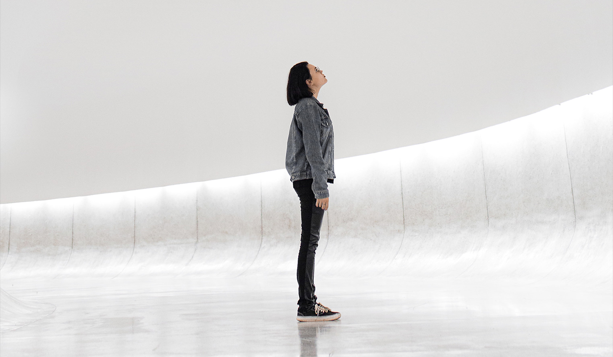 Woman looking up in a white room