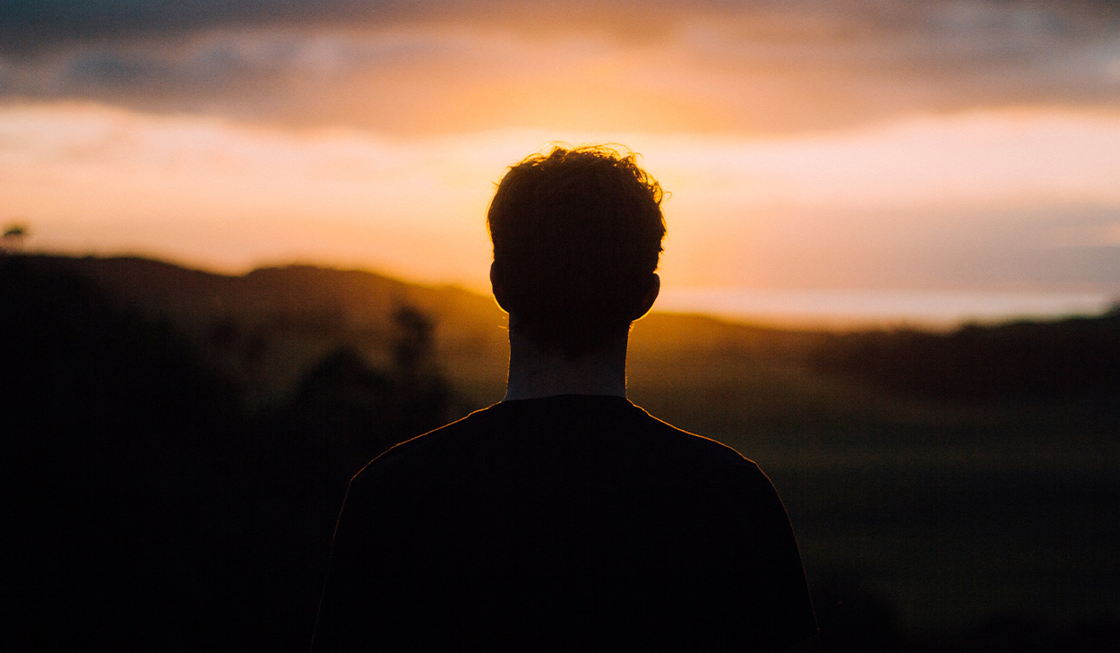 Man looking into the sunset