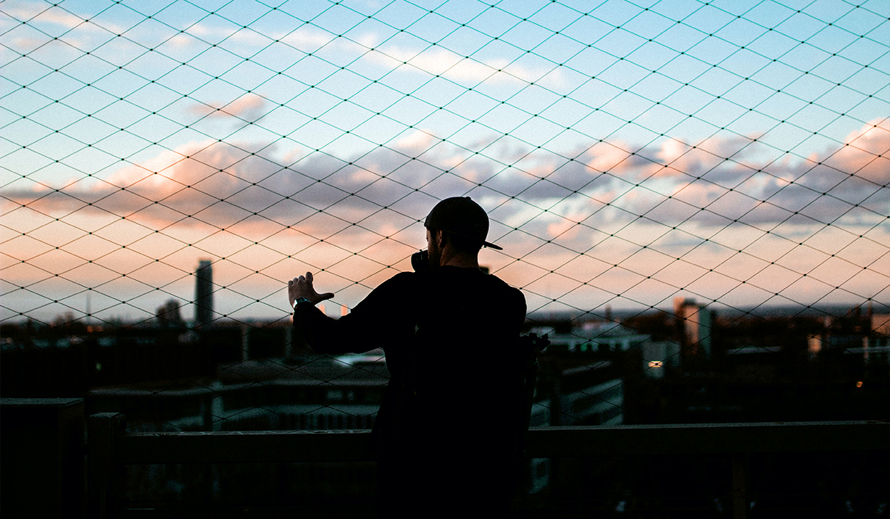 Man holding a fence