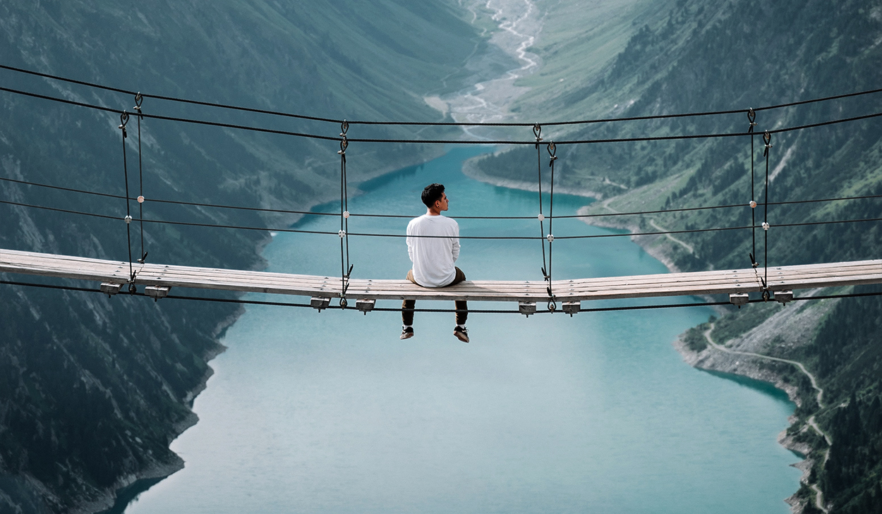 Man sitting on a bridge