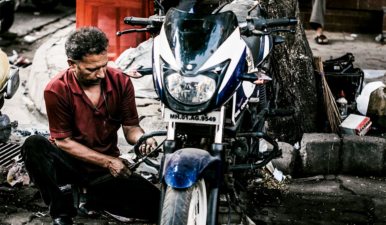 Man fixing a motorcycle