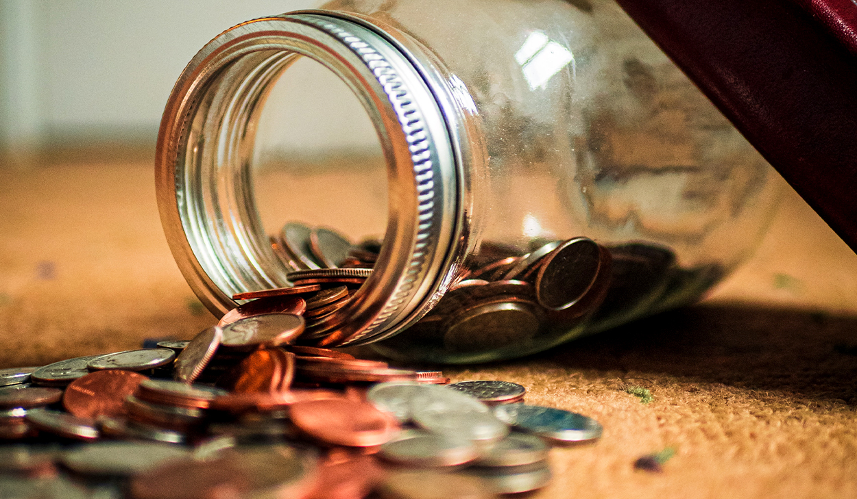 Jar with coins tipped over