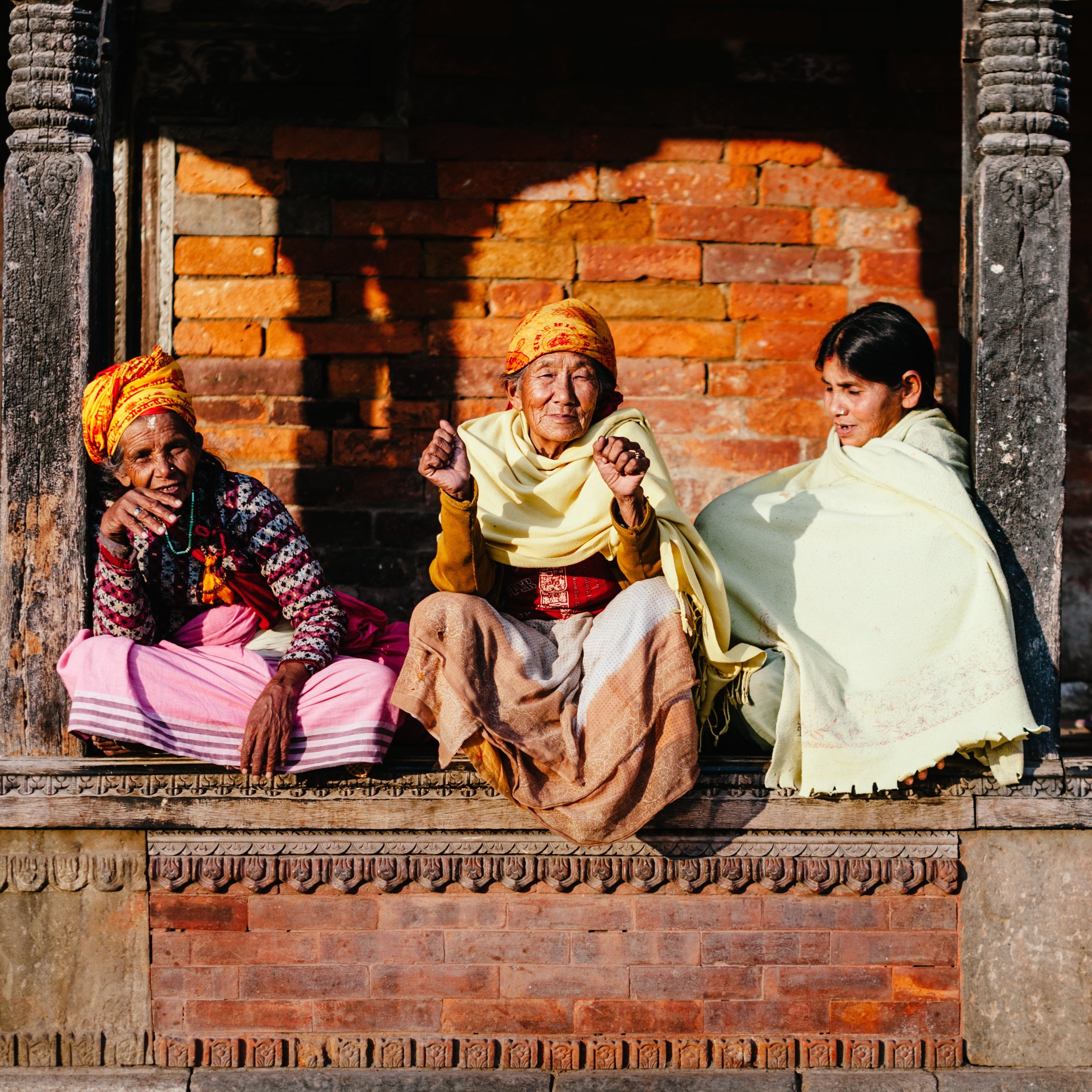 Women sitting on a building