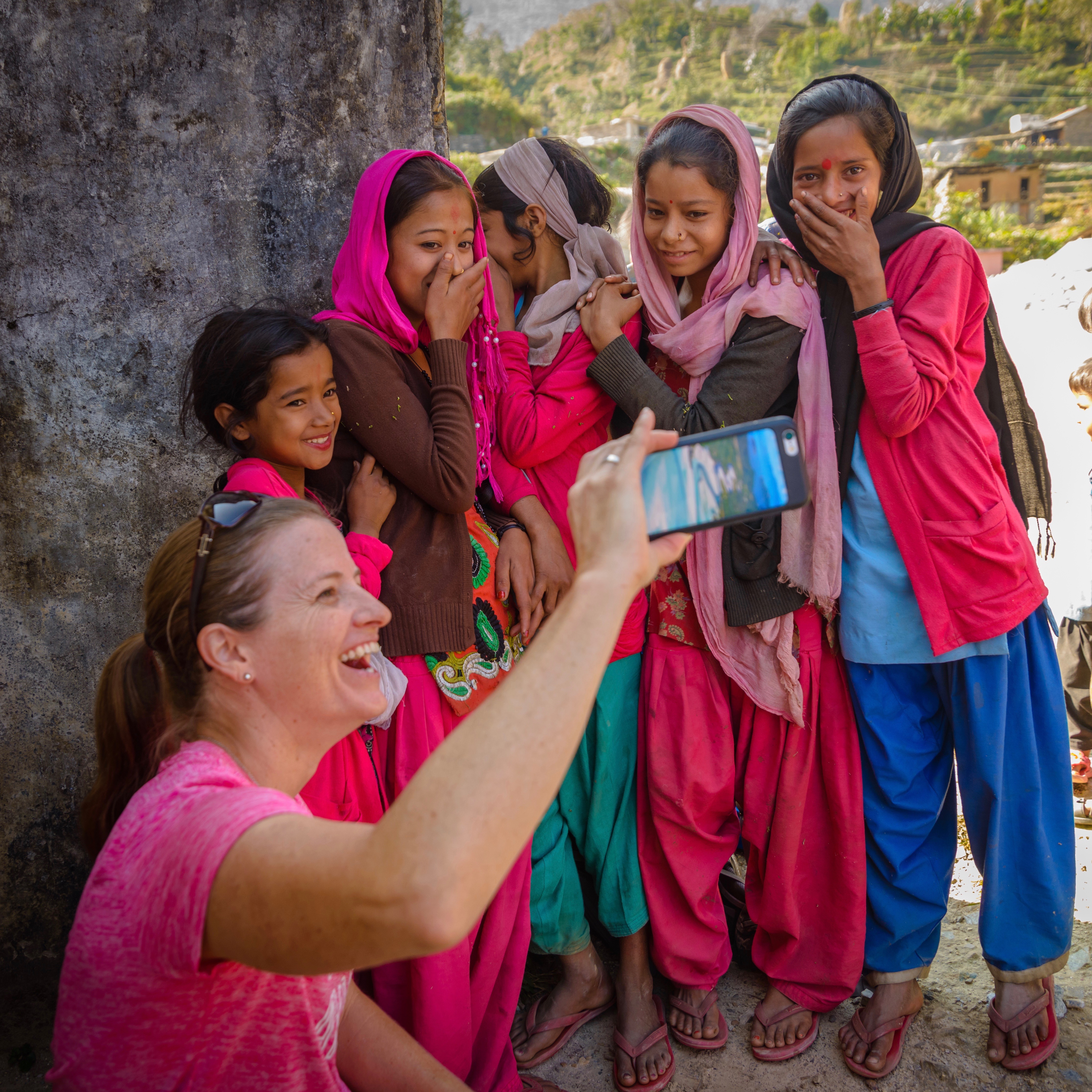 Woman taking a selfie with Indian girls