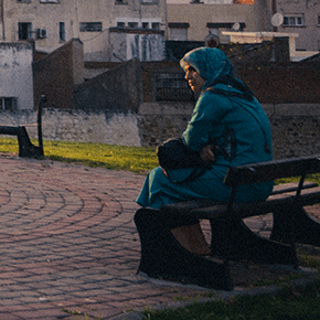 Muslim woman sitting on a bench