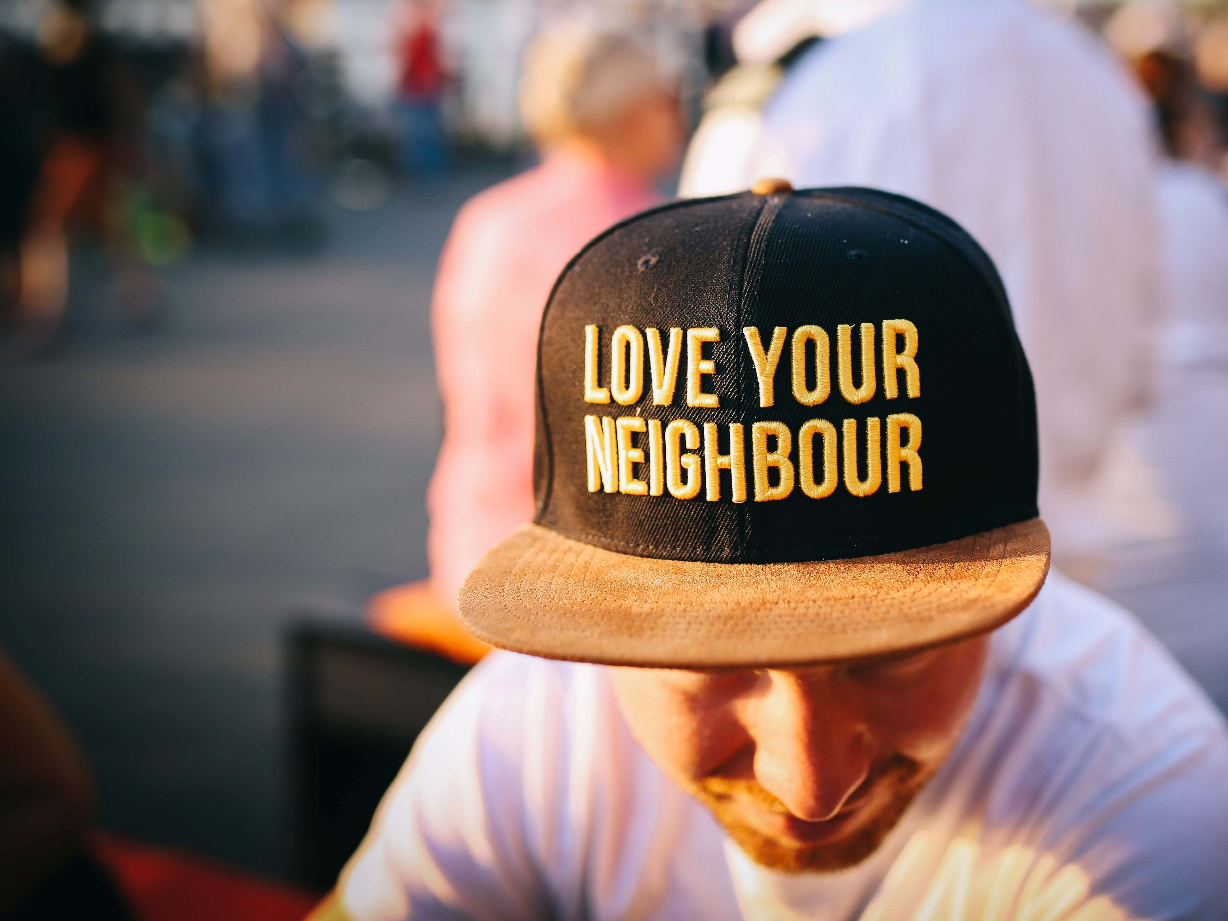 Man wearing a cap that says love your neighbor