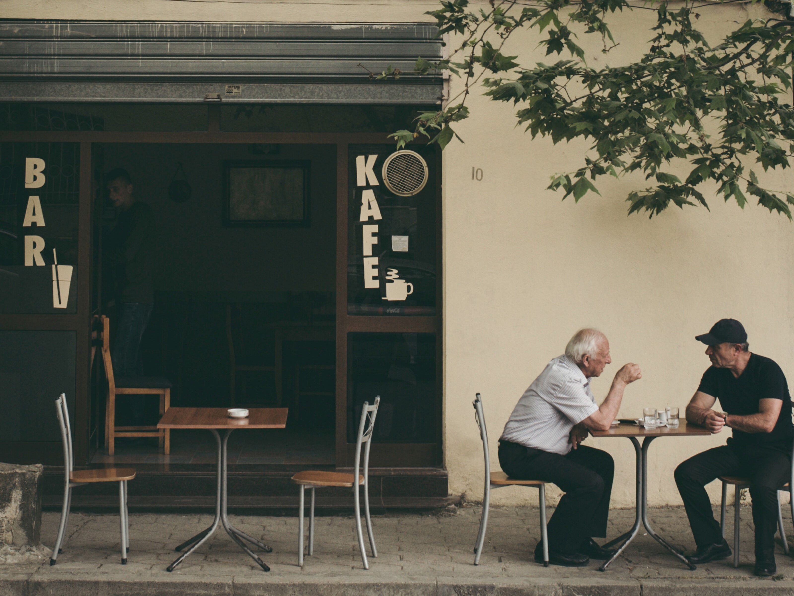 Two men sitting at a cafe