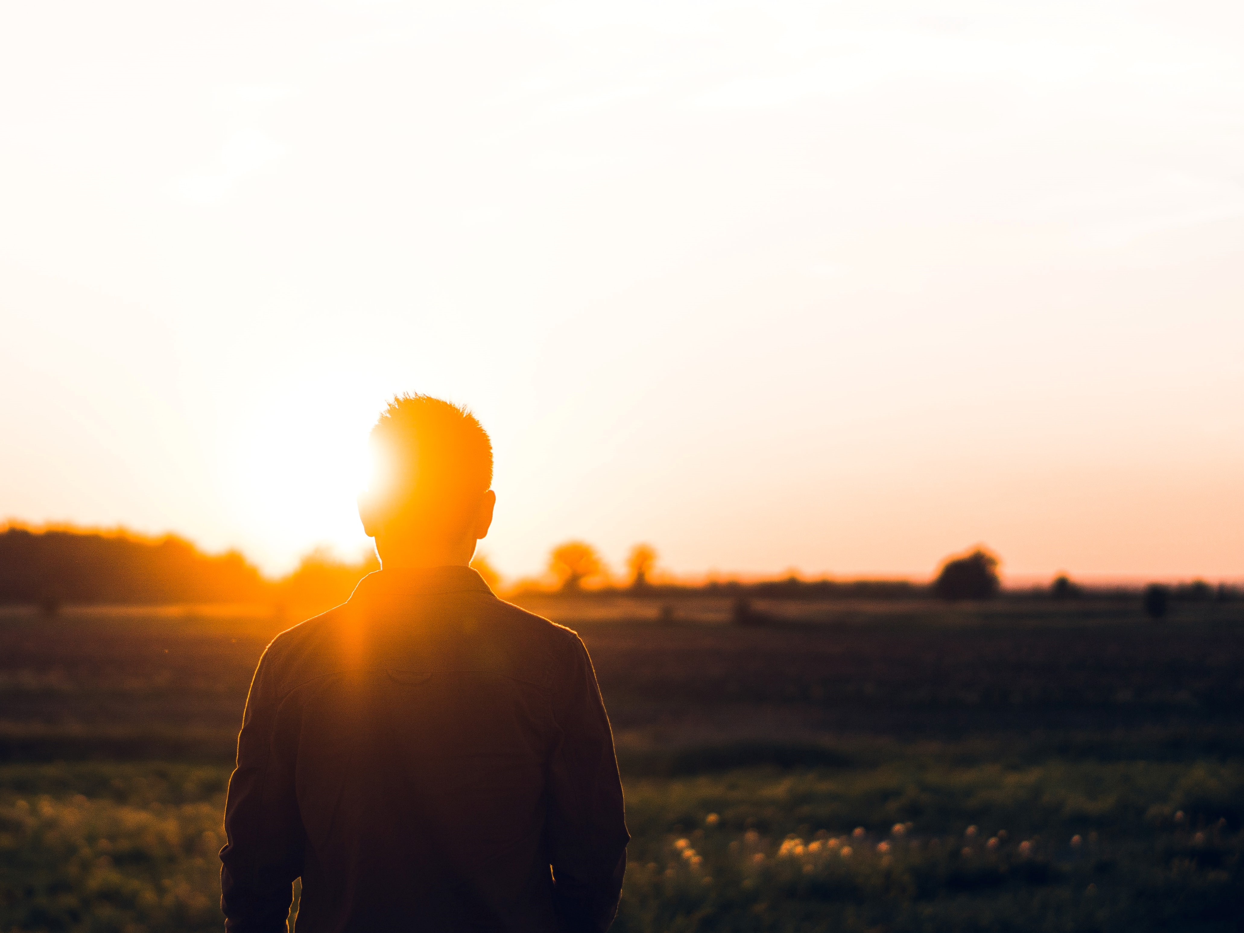 Man standing in the light of a sunrise