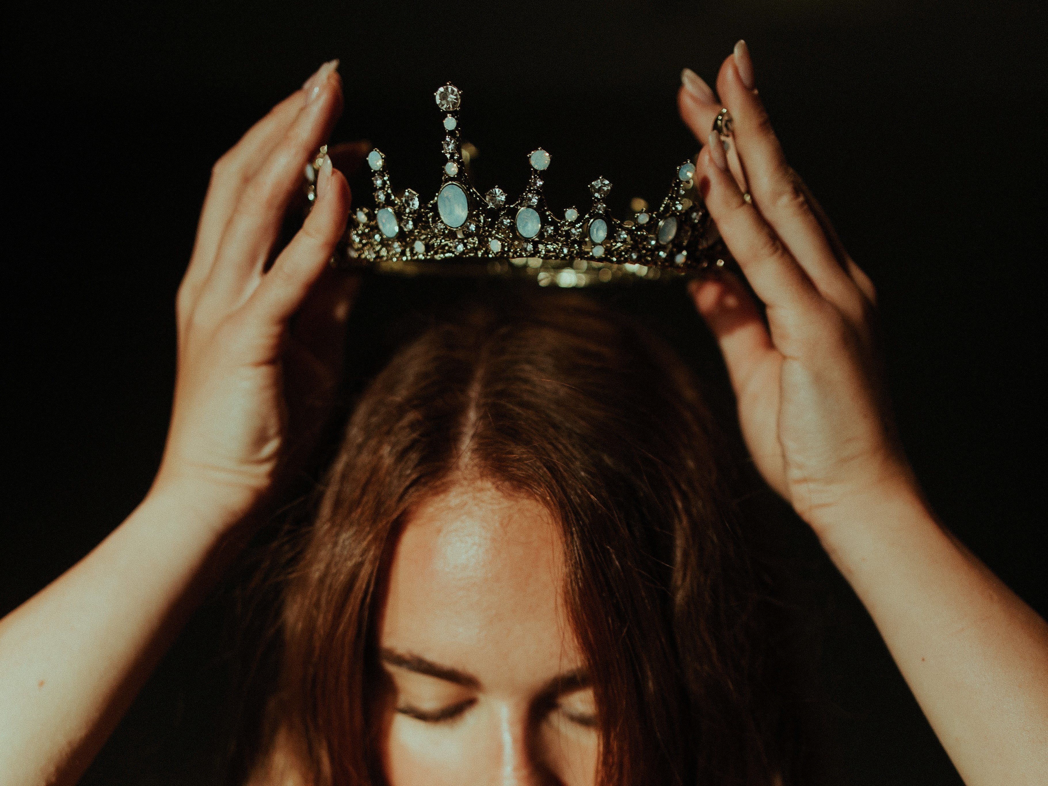 Woman putting a crown on