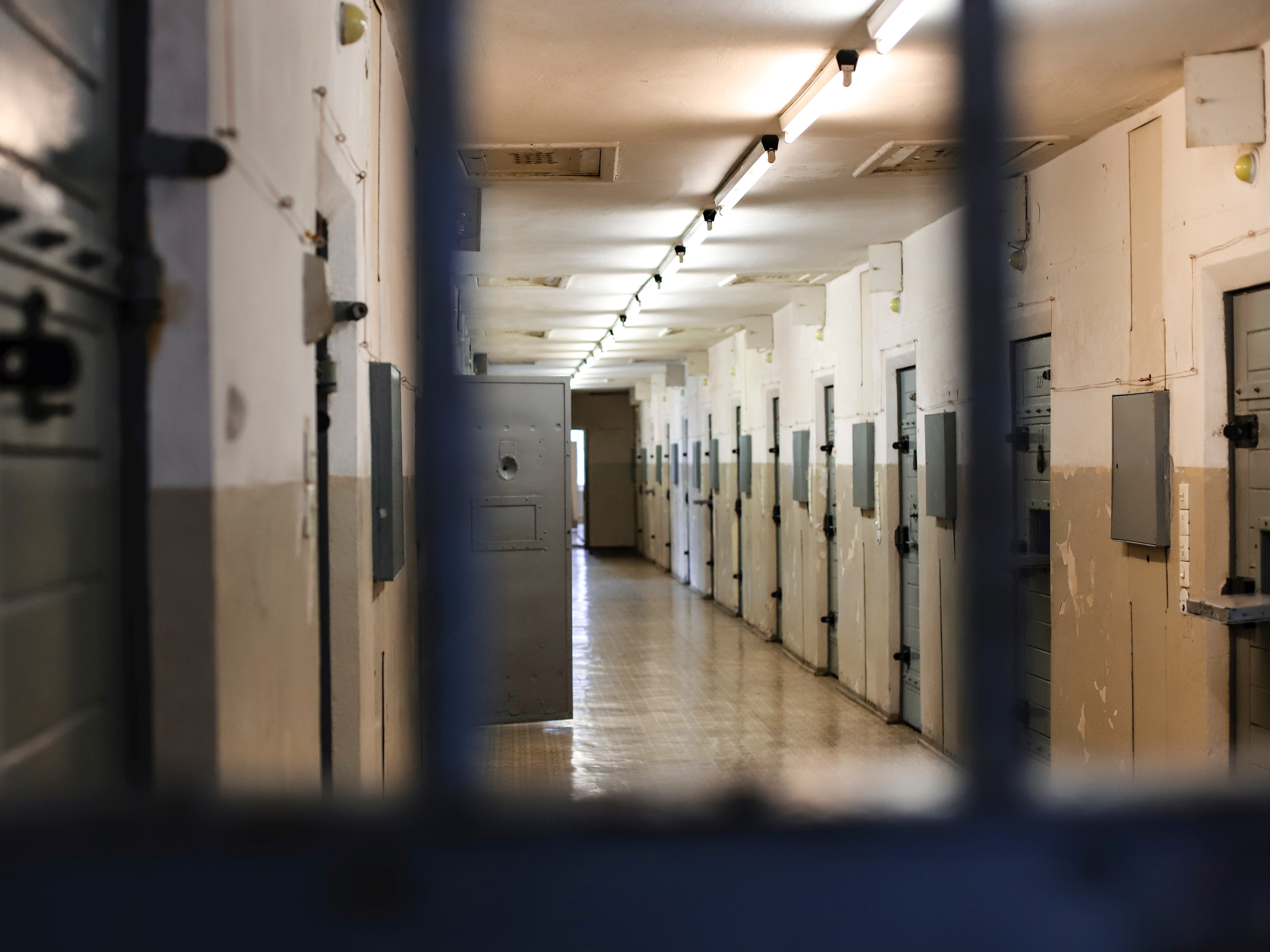 Prison hallway through bars