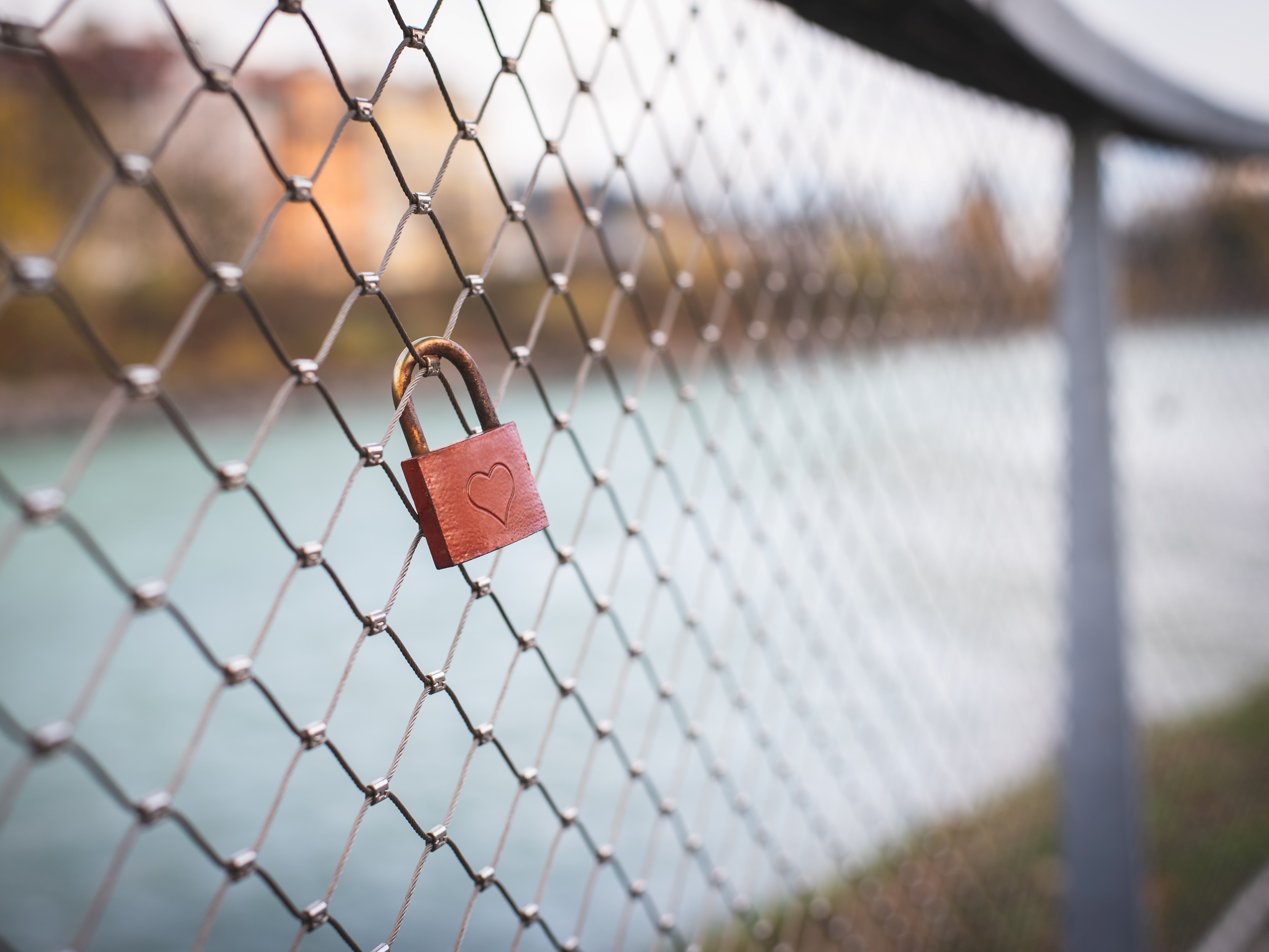 Lock with a heart on a chain fence