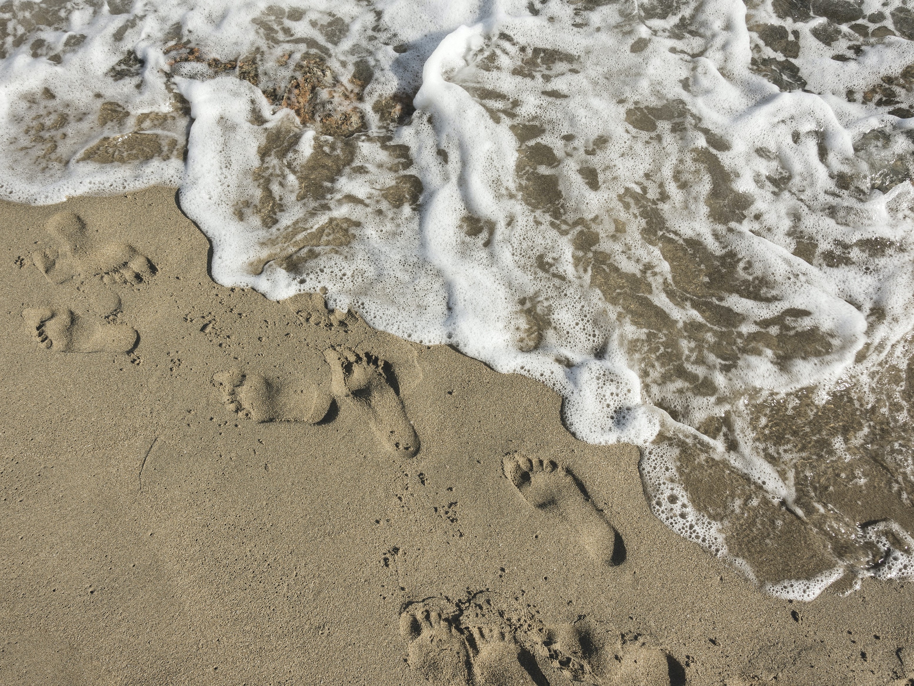 Footprints in the sand by tide